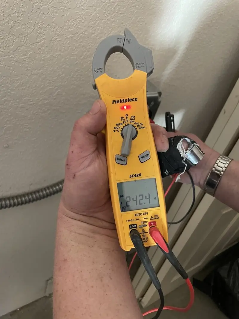 Voltage testing with clamp meter during Outlet Installation in Woodbridge
